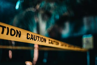 Caution tape on dark background.