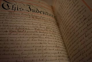 A photo of what appears to be a historical document of an Indenture. It is written in cursive script. It is quite lengthy, and the two pages are filled with text.