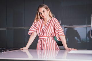 blonde beautiful women resting her arms on the counter in the kitchen