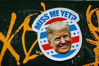 A sticker of former President Trump which reads: “Miss me yet?”