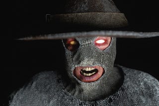 A scary man in a grey mask and large hat