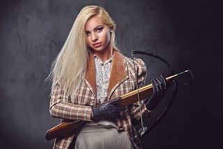 Sexy young woman with a loaded bow and arrow