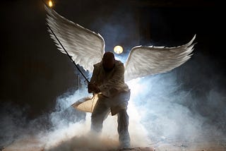 Dark silhouette angel with white wings on a cloud with a fishing pole.