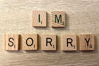 Scrabble letters spelling out the words “I’m sorry”