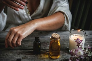 Image of person using a dropper to put a medicinal tincture on their forearm.