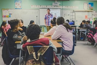 Students listening to a teacher