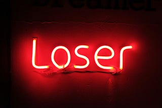 Neon sign saying “loser”