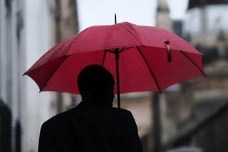 man with a red umbrella