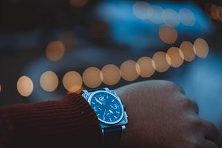 An arm with an analog wristwatch.