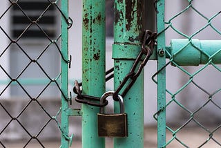 A padlock on a closed gate