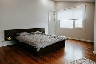 a bedroom practically empty except for bed