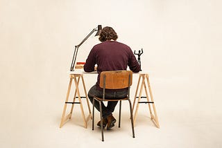 A man sits at a desk.