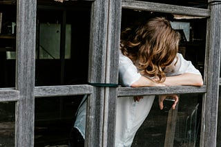 Woman leaning out of a window.
