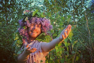A garlanded dude welcoming you in the middle of the nature.