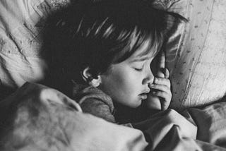 This child appears to have fallen asleep sad, as though the world around him does not hear what he feels.