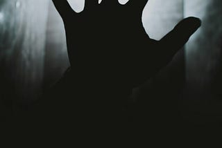 Grayscale image of a human hand silhouette showing five fingers. Alt text to show the importance of alt text.