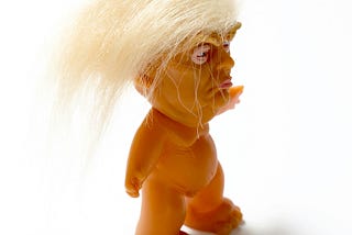 A doll caricature of President Trump — with wild hair and no clothes.