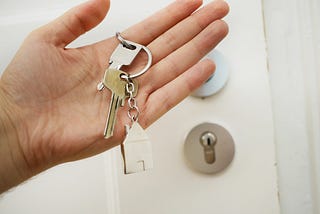 hand holding the keys to a house