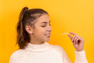 a girl holding an invisible braces