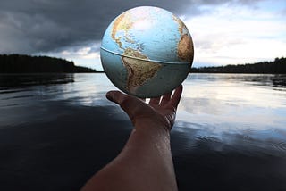 Hand holding a globe of the world