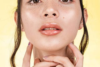 Woman with light skin in dewy complexion with glossed lips