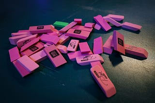 A small, messy pile of pink erasers