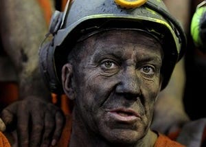 Picture of a miner with hard hat on.