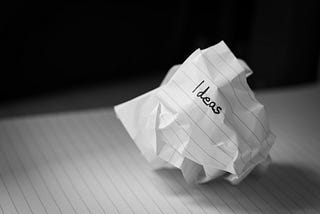 A paper ball with the text “ideas” writing on it.