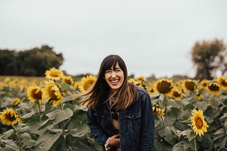 Woman smiling in a field of flowers