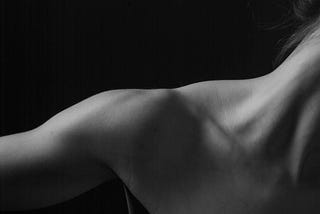 B & W photo  of a woman’s shoulder and neck