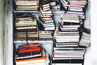 Piles of saved journal on a closet shelves