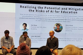 Sal Khan, Chris Piech, and John Mitchell sitting on stage in front of a slide projected on the wall titled “Realizing the Potential and Mitigating the Risks of AI for Education”