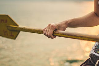 Close-up of a hand gripping an oar, symbolizing taking control of your life and actively steering toward your goals.