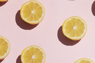 Stylized picture of lemons against a pink background