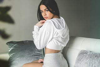 a woman looking back at the camera in a sexy pose