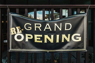 A (re-)grand opening sign — photo by Tim Mossholder