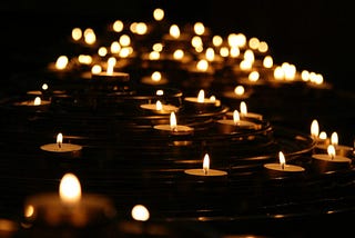 A line of candles in the darkness