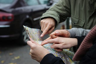 Drivers consulting a paper map