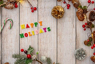 Happy holidays lettering on a plank board