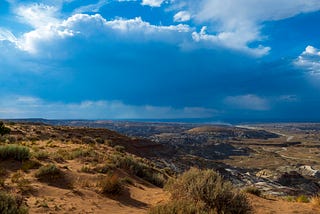 Passing clouds in the desert with tumbleweeds in the foreground