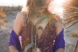 A woman with peacock feathers in her hand
