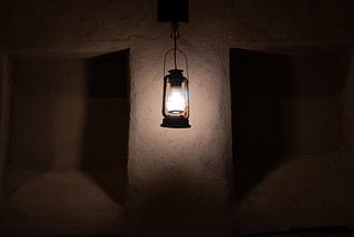 a lantern on the wall of an asylum