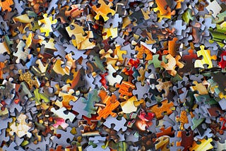 Lots of jig-saw puzzle pieces, jumbled together