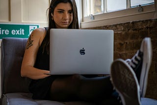 Woman working with a MacBook Pro at a tech company
