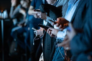 An image of students holding mobile phones