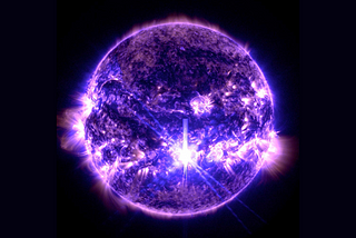 An image of the Sun in ultraviolet, which appears purple. A bright white spot in the bottom third of the image is caused by a large solar flare.