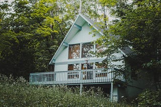House partially hidden by trees