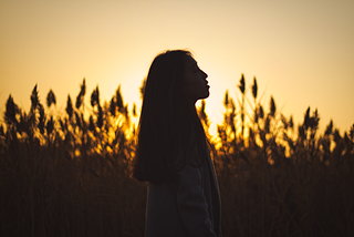 Contemplative woman in the field