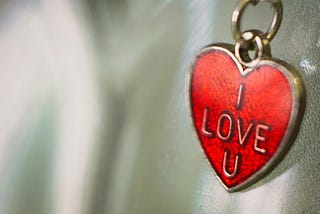 heart-shaped locket with “I love you” written on it