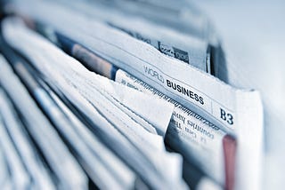 a stack of newspapers filed upright